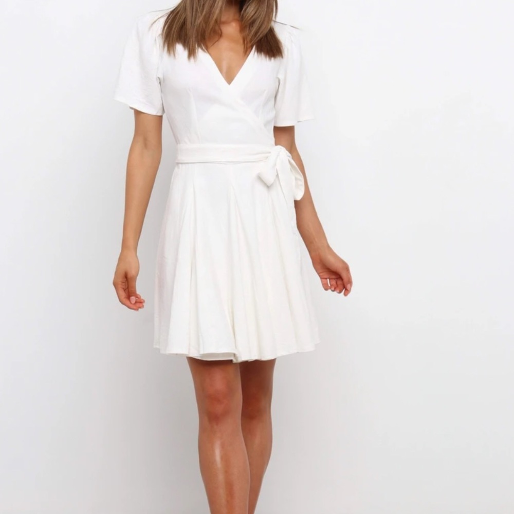 Purchased on Petal and Pup. Into brand. Ivory wrap dress.